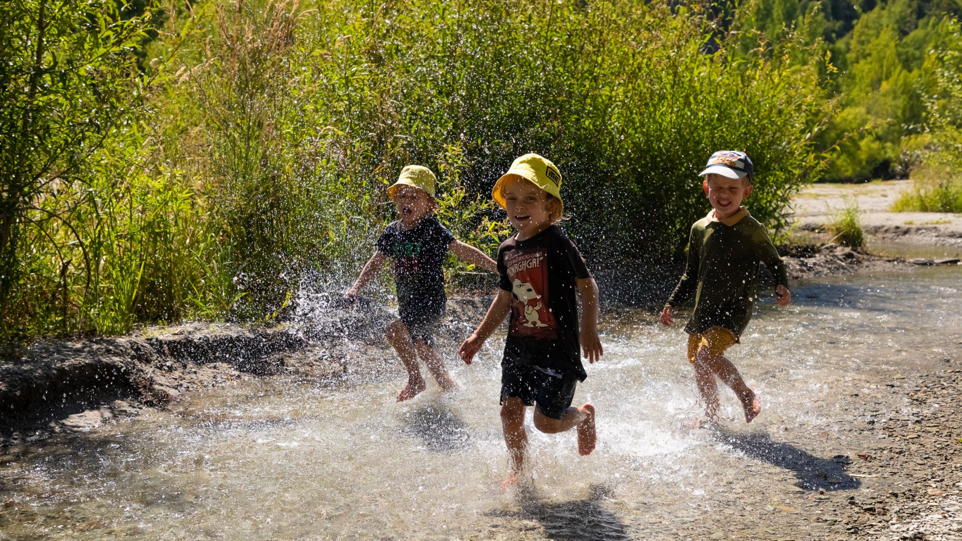 Children enjoying water play in the Bush Creek/Arrow River on Arrowtown's outskirts